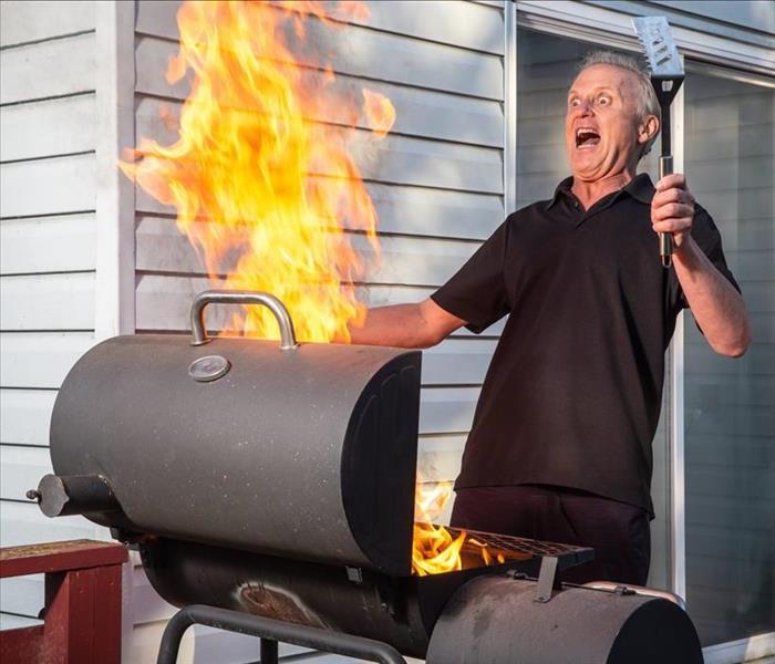 shocked man with flames coming from grill