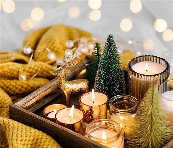holiday decorations and candles on a tray