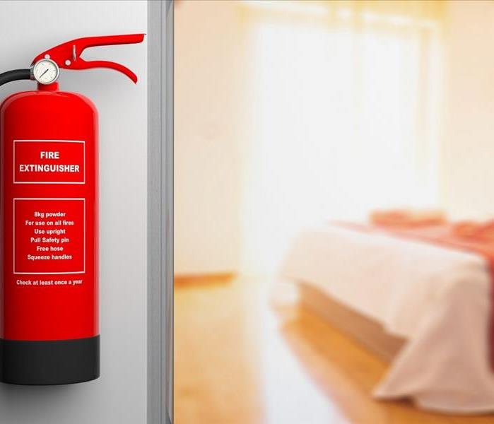 red fire extinguisher on wall outside bedroom